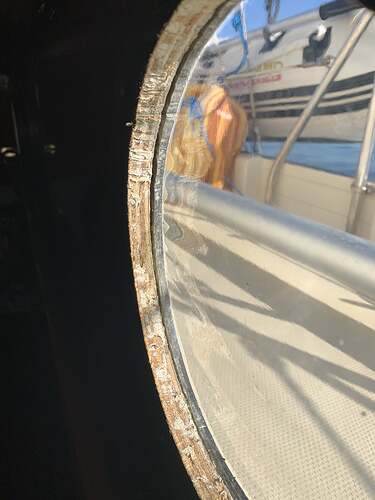 mid starboard porthole with panel starting to detach-min.jpg
